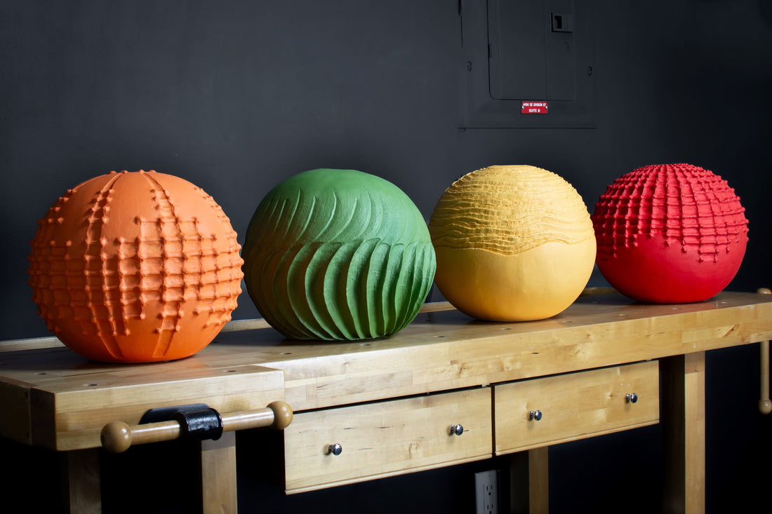 sculpted clay vessels in bright colors